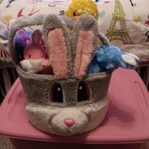large grey plush bunny basket with small bunnies inside and one yellow chick